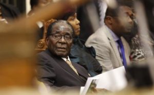 Zimbabwe's President Mugabe listens as FM Chinamasa presents the country's 2014 National Budget to Parliament in Harare