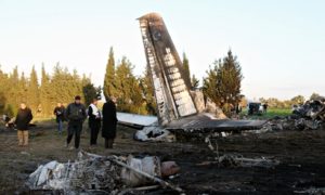 Tunisian police inspect the wreckage of the Libyan military plane near Grombalia
