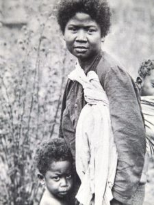 A BLACK WOMAN AND CHILDREN IN THE PHILIPPINES