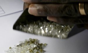 A man checks raw diamonds at the gold and diamond department at Sierra Leone Central Bank in Freetown