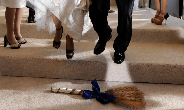 Interracial couples jumping the broom.