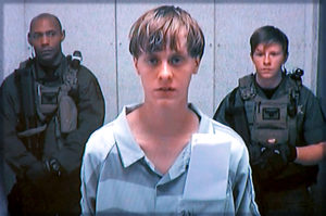 Dylann Storm Roof appears by closed-circuit television at his bond hearing in Charleston, South Carolina June 19, 2015 in a still image from video. A 21-year-old white man has been charged with nine counts of murder in connection with an attack on a historic black South Carolina church, police said on Friday, and media reports said he had hoped to incite a race war in the United States. REUTERS/POOL TPX IMAGES OF THE DAY - RTX1HB17