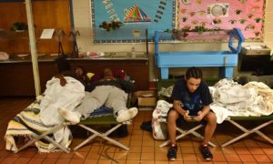 Flood-displaced residents rest at a temporary shelter at St Andrews middle school in Columbia, South Carolina. Photograph: Mladen Antonov/AFP/Getty Images
