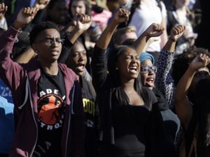 Students cheer after the announcement that University of Missouri System President Tim Wolfe would resign. JEFF ROBERSON / AP