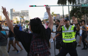 A City of Miami police officer stops traffic as demonstrators march through the Wynwood neighborhood to protest police abuse on Dec. 7, 2014 in Miami, Florida. The protest was one of many that have take place nationwide after grand juries investigating the deaths of Michal Brown in Ferguson, Missouri and Eric Garner in New York failed to indict the police officers involved in both incidents. (Joe Raedle/Getty Images)
