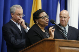 Valerie Wilson, center, school business administrator for the Newark Public Schools system, speaks at a news conference addressing recent finding of lead levels in Newark schools, Wednesday, March 9, in Newark, N.J. Standing with Wilson are Cristopher Cerf, left, Superintendent of Newark Public Schools, and Anthony Ambrose, acting director of public safety for Newark. Elevated levels of lead caused officials in New Jersey's largest school district on Wednesday to shut off water fountains at 30 school buildings until more tests are conducted, officials said. (Julio Cortez/AP)