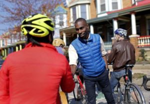 Black Lives Matter activist DeRay McKesson talks with cyclists in the Charles Village neighborhood of Baltimore. Photo courtesy of Patrick Semansky/AP.