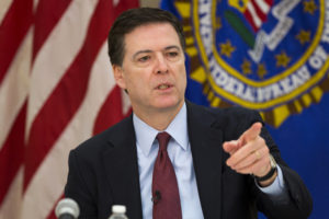 FILE - This is a Wednesday, March 25, 2015 file photo of FBI director James Comey as he gestures during a news conference at FBI headquarters in Washington. (AP Photo/ Evan Vucci, File)