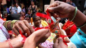 Sex workers distribute red ribbons a symbol of the fight against Aids in a rally