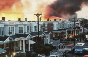 Flames shoot skyward at the MOVE compound in West Philadelphia on May 13, 1985. J. Scott Applewhite/AP