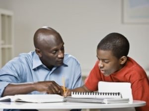 African father helping son with homework