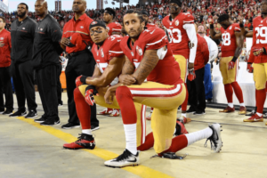 Colin Kaepernick kneels during national anthem, pictured with teammate Eric Reid (Twitter)