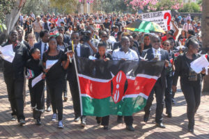 Kenyans and supporters of the Kenyan Solidarity March walk proudly with the Kenya flag at Wits University following the Garissa attacks.