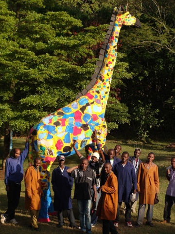Employees at Ocean Sole show off Twiga the giraffe 