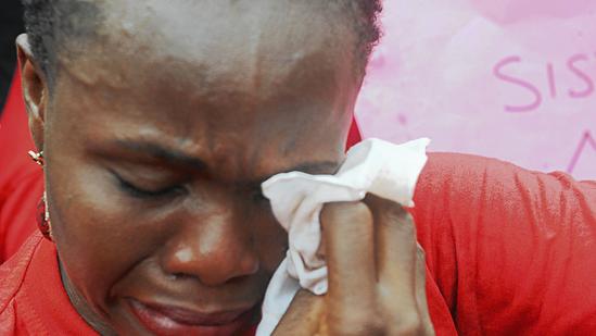 Mother of kidnapped girl weeps during rally in Abuja