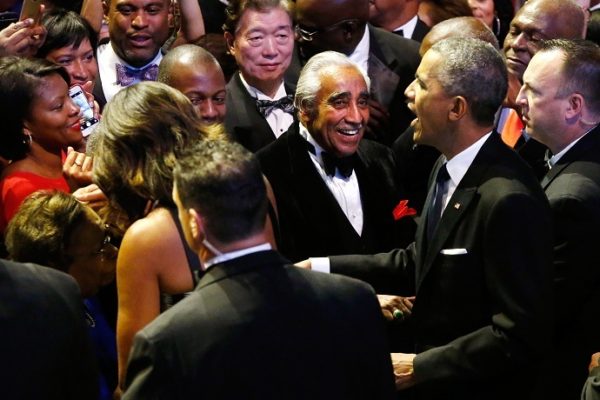 U.S. Representative Rangel smiles as President Obama and first lady Michelle Obama greet members of the audience at the Congressional Black Caucus Foundation dinner in Washington