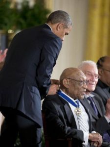 President Obama adorns Charlie Sifford with Presidential Medal of Freedom.