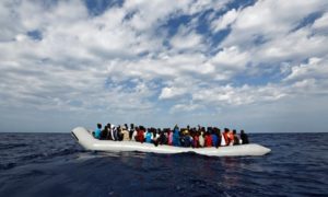A rubber dinghy with 104 sub-Saharan Africans on board waiting to be rescued