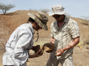 Archaeologists Sonia Harmand and Jason Lewis, of Stony Brook University, examine stone tools. Initially, she says, the scientists didn't realize the tools they found dated to hundreds of thousands of years before the first humans.