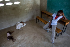 Milene Monime, 16, in a classroom in Haiti on Thursday, a day after being deported from the Dominican Republic. Her 2-month-old son slept with another child. (Rebecca Blackwell/AP)