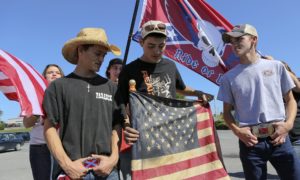  Christianburg high school students bearing American and Confederate flags gather after being suspended from school on Thursday. {Matt Gentry/AP}