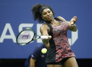 Serena Williams returns a shot to Venus Williams during U.S. Open (Julio Cortez / Associated Press) 