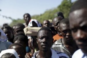 Haitians from Anse-a-Pitres and residents of refugee camps for Haitians returning from the Dominican Republic, attend Sunday mass at the camp on the outskirts of Anse-a-Pitres