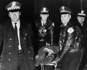 Chicago police cannot contain their glee as they remove the body of Fred Hampton, leader of the Illinois Black Panther Party, who was assassinated by Chicago police in December 1969.