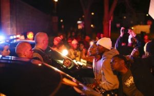 Demonstrators chanted at Minneapolis Police Officers at the side entrance to the 4th Precinct station on Morgan Ave. N. Sunday night in Minneapolis. (Jeff Wheeler/Star Tribune)