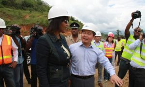 Chinese ambassador to Jamaica Dong Xiaojun shows Portia Simpson