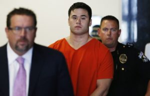 FILE - In this Sept. 3, 2014, file photo Daniel Holtzclaw, center, arrives for a hearing in Oklahoma City. Holtzclaw, an Oklahoma City police officer, is accused of sexually assaulting 13 women while on patrol. (AP Photo/Sue Ogrocki, File)