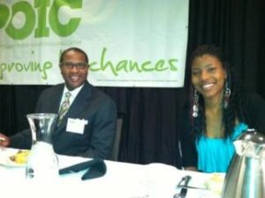 Michael Holton (L) was the emcee at POIC's Work Opportunities Breakfast. Lakeisha Holloway, a graduate, received a CARE Role Model award (The Skanner News)