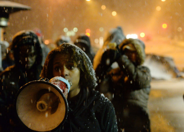 A demonstrator rallys the crowd of about the 200 people in a snow storm during the Black Lives Matter protest in front of the Minneapolis Police Department 4th Precinct building on Plymouth Avenue in North Minneapolis on Monday, November 30, 2015. (Pioneer Press: John Autey)