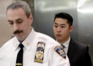 New York City Police (NYPD) officer Peter Liang (R) is escorted by a court officer inside the criminal court after an arraignment hearing in the Brooklyn borough of New York City February 11, 2015. BRENDAN MCDERMID / Reuters