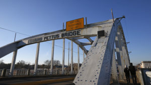 People walk across the Edmund Pettus Bridge in Selma, Alabama, January 8, 2015. The bridge was the scene of a major civil rights confrontation in March, 1965, in which police beat protesters who were marching to demand voting rights for African Americans. Picture taken January 8, 2015. REUTERS/Jim Young (UNITED STATES - Tags: ENTERTAINMENT ANNIVERSARY POLITICS) - RTR4KS5P