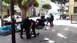 LAPD officers tackle Charly "Africa" Keunang. Keunang was shot dead by officers in March 2015. 