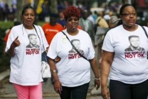 At right, Eric Garner's widow, Esaw Garner (l.), daughter Emerald Snipes Garner (l.) march at rally demanding police reforms last year in Brooklyn. (Eduardo Munoz/Reuters)