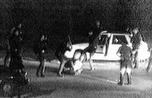 An image from a video shows L.A. police officers beating Rodney G. King. Police delivered 56 blows to King during the 1991 altercation that marked the beginning of the end of the baton's reign. (George Holliday via Associated Press)