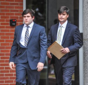 Former University of Mississippi student Austin Reed Edenfield, left, with attorney Clark Trout, leaves federal court Thursday, March 24, 2016, after pleading guilty to placing a noose on the school's statue of its first black student, in Oxford, Miss. Edenfield waived indictment and pleaded guilty to a misdemeanor charge before U.S. District Judge Michael Mills. The charge says Edenfield helped others threaten force to intimidate African-American students and employees at the university. Edenfield will be sentenced on July 21 and faces up to a year in prison and a $100,000 fine. The government has recommended probation. (Bruce Newman/Oxford Eagle via AP)