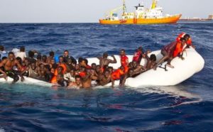 Migrants sit in a rubber dinghy during a rescue operation by SOS Mediterranee ship Aquarius off the coast of the Italian island of Lampedusa in this handout received April 18, 2016. SOS Mediterranee/Handout via REUTERS