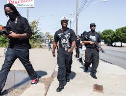 Huey P. Newton Gun Club members march through the Dixon Circle neighborhood of Dallas. (Bobby Scheidemann) 