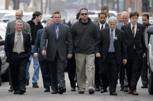 Former New Orleans police officers, along with their lawyers, head to turn themselves in at the city jail on Jan. 2, 2007. Photo courtesy of Bill Haber/Associated Press