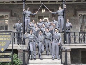 Members of the U.S. Military Academy's Class of 2016 pose for a photo with their fists raised in front of their barracks. 
