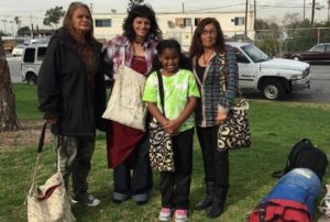 Khloe Thompson, 9, poses with recipients of her Kare Bags. Photo courtesy of Instagram.