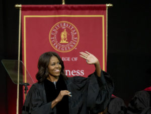 First lady Michelle Obama waves towards the crowd after walking out on stage just before she delivers the commencement address at Tuskegee University, Saturday, May 9, 2015, in Tuskegee, Ala. (AP Photo/Brynn Anderson)