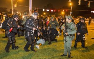 Police in riot gear taking down protesters in Baton Rouge. Photo courtesy of Getty Images. 
