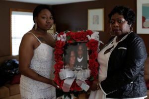 Allysza Castile, the sister of Philando Castile, and their mother, Valerie, holding a photo of the slain Minnesota man. Photo by Joshua Lott for the New York Times.