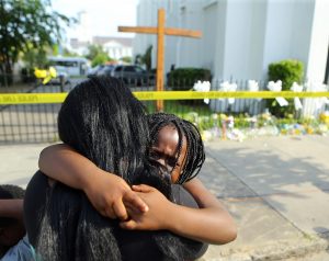 Kearston Farr hugs her 5-year-old daughter Taliyah visiting a memorial in front of the Emanuel AME Church on Friday, June 19, 2015 in Charleston, S.C. Photo by Curtis Compton. Atlanta Journal-Constitution/AP