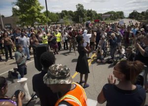 Activists speak to a crowd outside of the St. Anthony Police Department headquarters on July 10.Source: Stephen Maturen/Getty Images