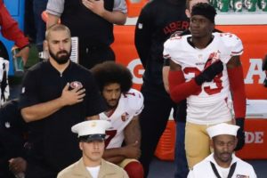 The 49ers' Colin Kaepernick kneeling during the national anthem in a protest of racial inequality. Credit Chris Carlson/Associated Press